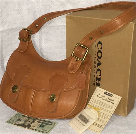 Attach the lightweight webbing strap to wear on the shoulder or crossbody. . Coach leatherware